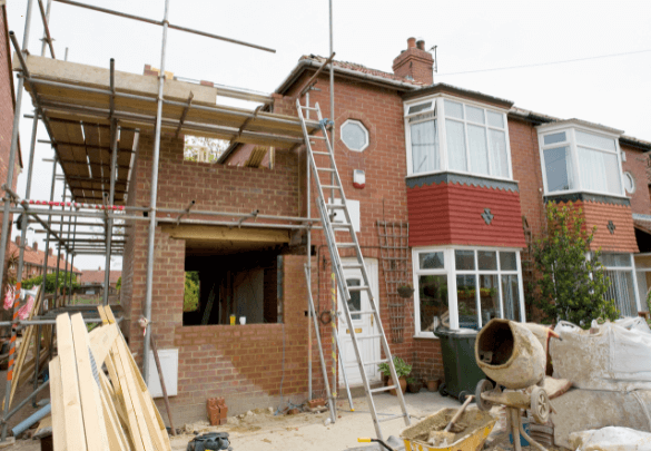 New-Kitchen Home extensions under construction with scaffolding and building materials, illustrating the process of expanding a residential property.