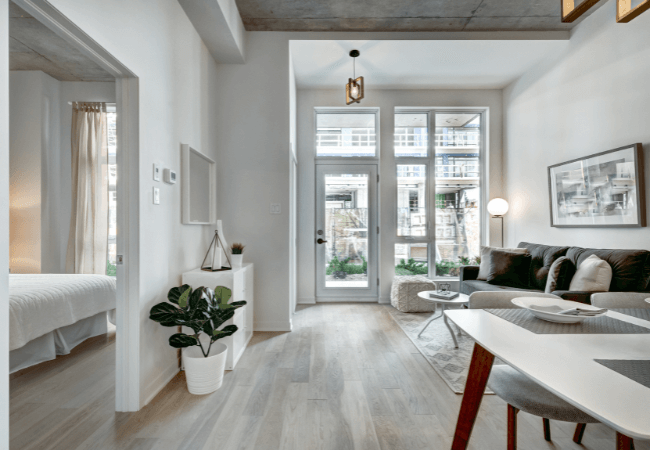 Bright, modern interior of a luxury build with large windows and contemporary decor.