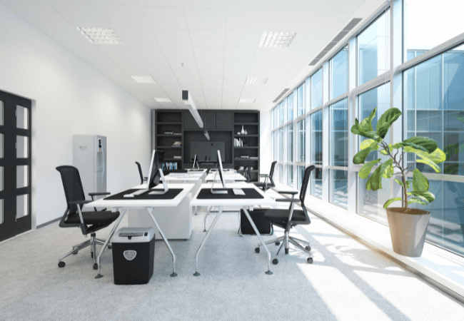 New-Kitchen Modern office interior with open workstations, large windows, and natural light