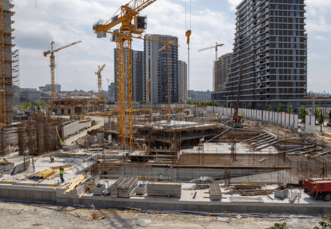 Construction site with cranes and ongoing building projects showcasing project management services.