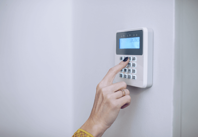 New-Kitchen Person using a keypad for home security system.